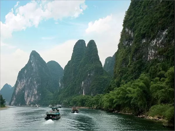 China, Guilin, Li River, River boats line the way along the River with its dramatic mountains