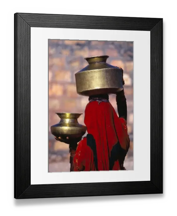 Framed Print : Asia, India, Rajasthan. A local woman in a red sari skillfully balances brass water Framed Print : Asia, India, Rajasthan. A local woman in a red sari skillfully balances brass water