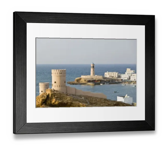 Framed Print : Oman, Sharqiya Region, Sur. Towers of Al Ayajh Fort  /  Sur Bay  /  Late Afternoon