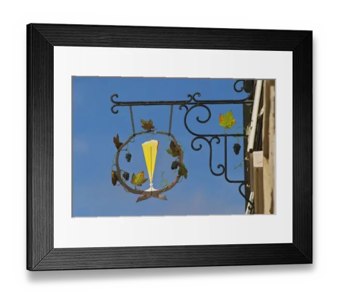 Framed Print : A wrought iron sign that illustrates the theme of champagne and wine production Framed Print : A wrought iron sign that illustrates the theme of champagne and wine production