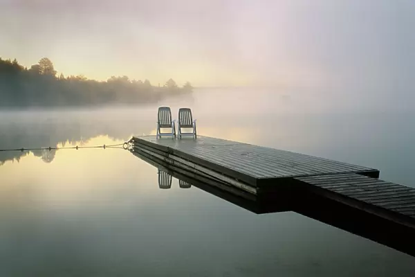 Canada, Ontario, Algonquin Provincial Park, Chairs on dock. Credit as: Nancy Rotenberg