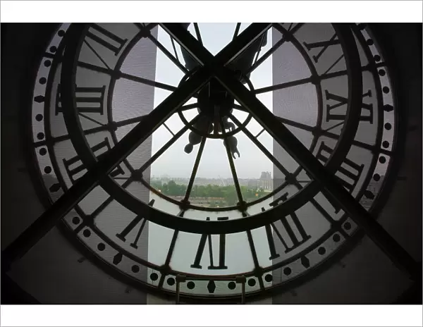 France, Paris. View across Seine River through transparent face of one of the clocks