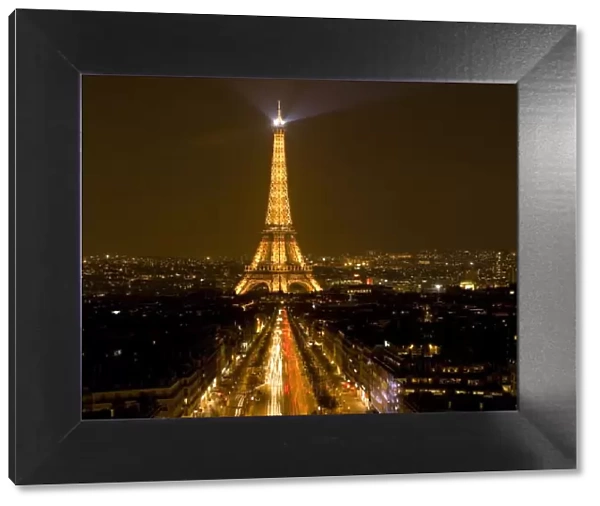 France, Paris. Nighttime view of Eiffel Tower and Champs Elysees (digital composite)