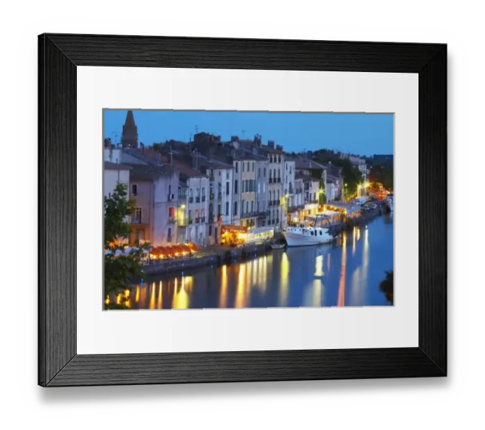 Framed Print : Restaurants along the l Herault river. L Herault river. A fishing boat. Agde town