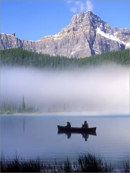Canoe fishing Waterfowl Lake, Banff National Park, Canada