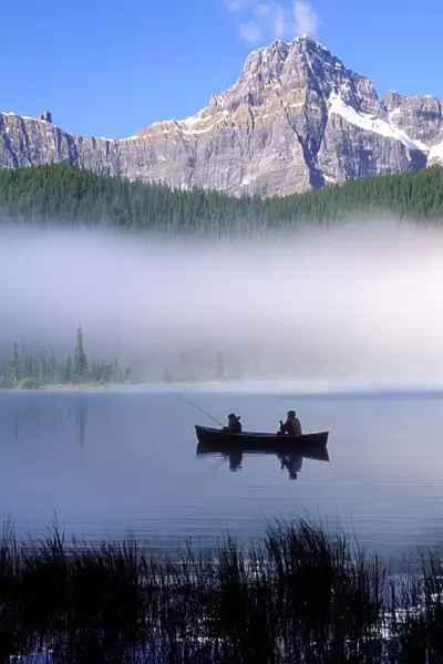 Canoe fishing Waterfowl Lake, Banff National Park, Canada