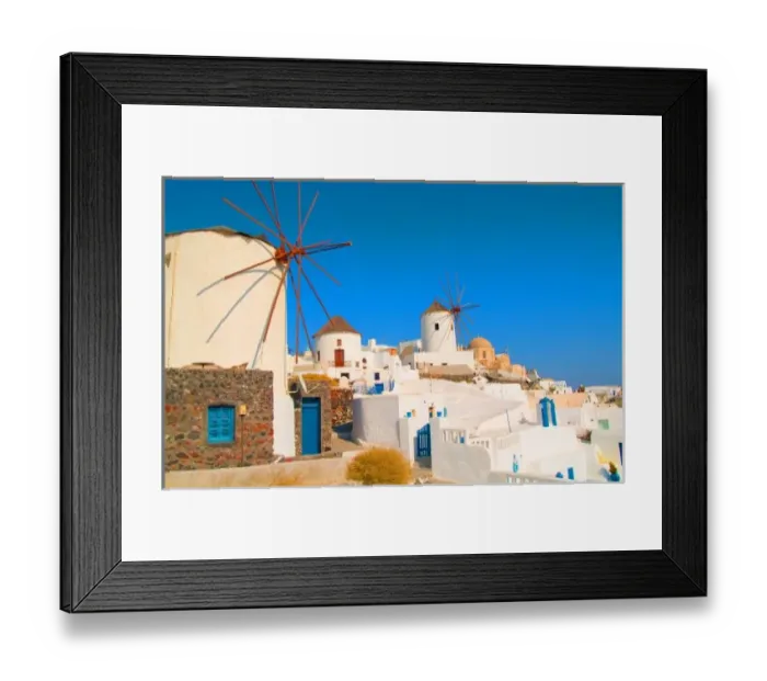 Framed Print : The white buildings and the windmills on the mountain cliffs of Oia, Santorini, Greece