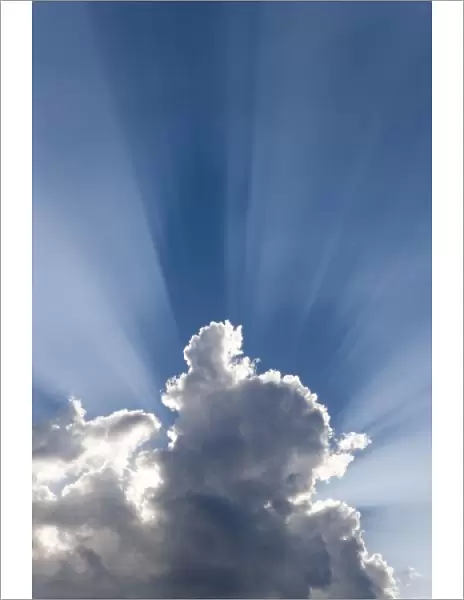 Crepuscular or Gods rays streak past cloud