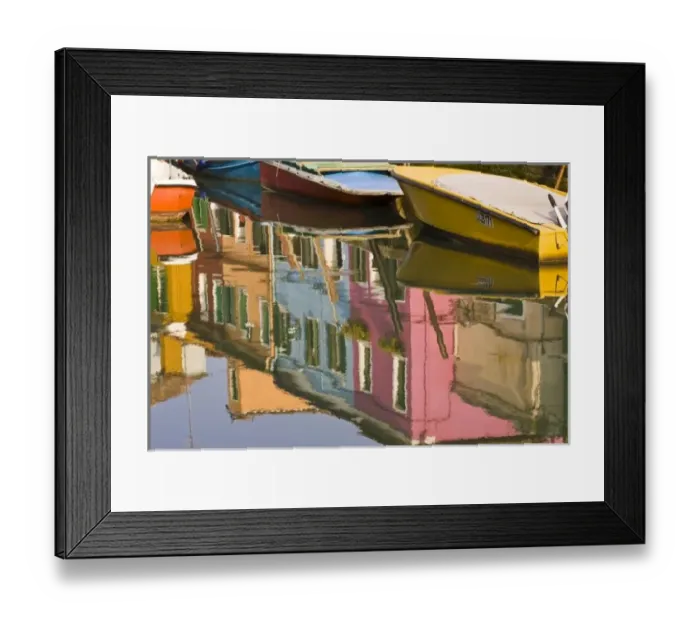 Framed Print : Italy, Burano. Boats on a canal with reflections of colorful houses on the water