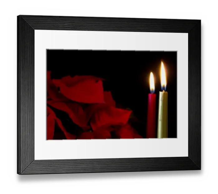 Framed Print : Holiday still life. Burning candles & poinsettia plant. Property released