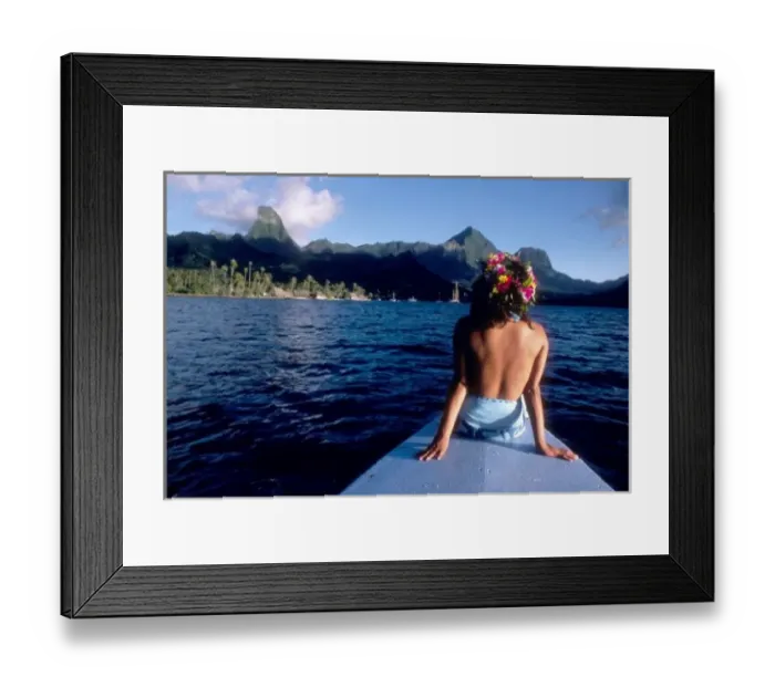 Framed Print : French Polynesia, Moorea. Woman enjoying view on bow of boat wearing flower garland
