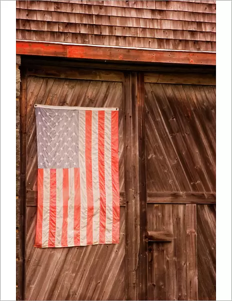 Maine, Faded American flag on door of old barn