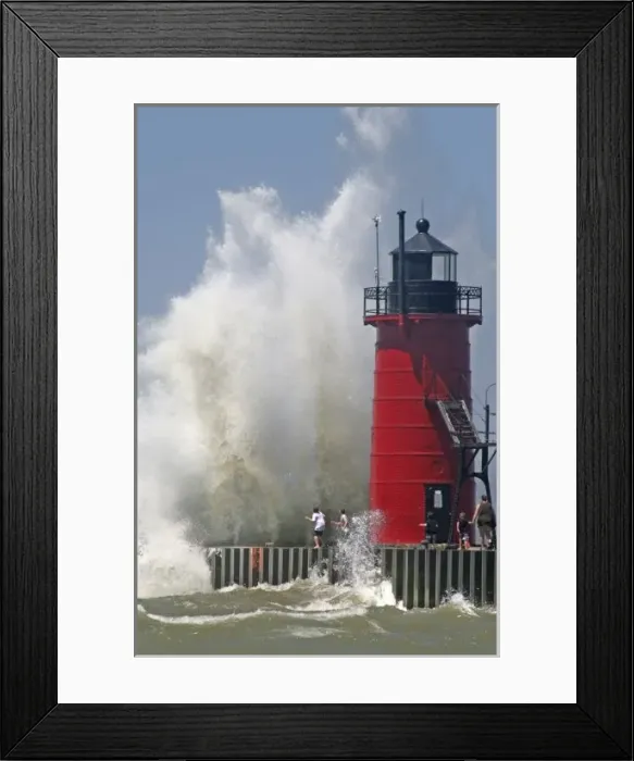 Framed Print : People on jetty watch large breaking waves in South Haven Michigan