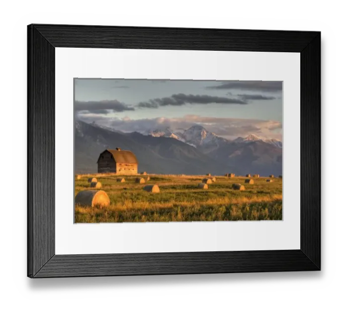 Framed Print : Old barn framed by hay bales and dramatic Mission Mountain Range in Montana
