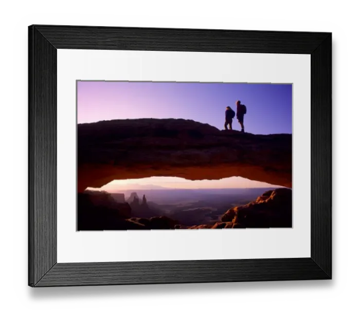 Framed Print : A couple watches sunrise from atop Mesa Arch in the Island-in-the-Sky region of Canyonlands Framed Print : A couple watches sunrise from atop Mesa Arch in the Island-in-the-Sky region of Canyonlands