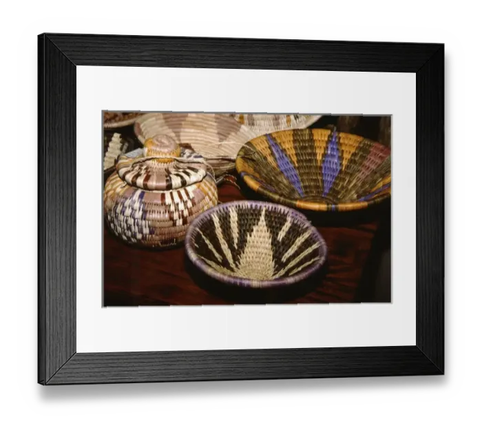 Framed Print : Africa, Botswana, Okavango Delta, Jao Reserve, Tubu Tree. Colorful camp staff made reed baskets