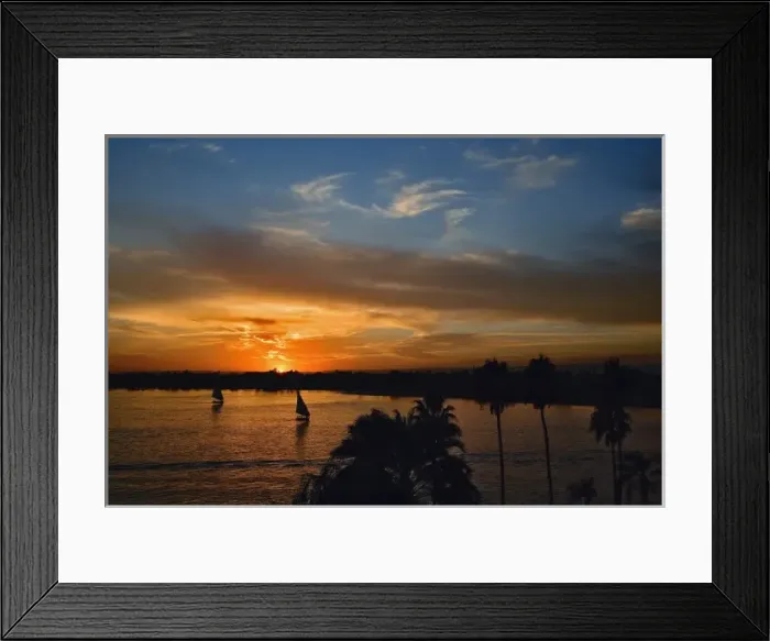 Framed Print : Pair of falukas and sightseers on Nile River at sunset, modern day Luxor, or ancient