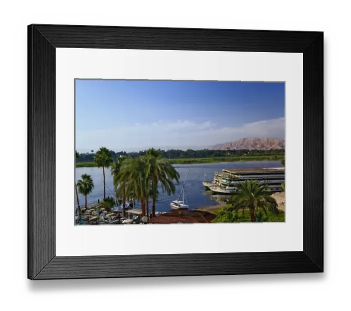 Framed Print : Nile River and docked sightseeing boats, and distant Valley of the Kings, from modern Framed Print : Nile River and docked sightseeing boats, and distant Valley of the Kings, from modern