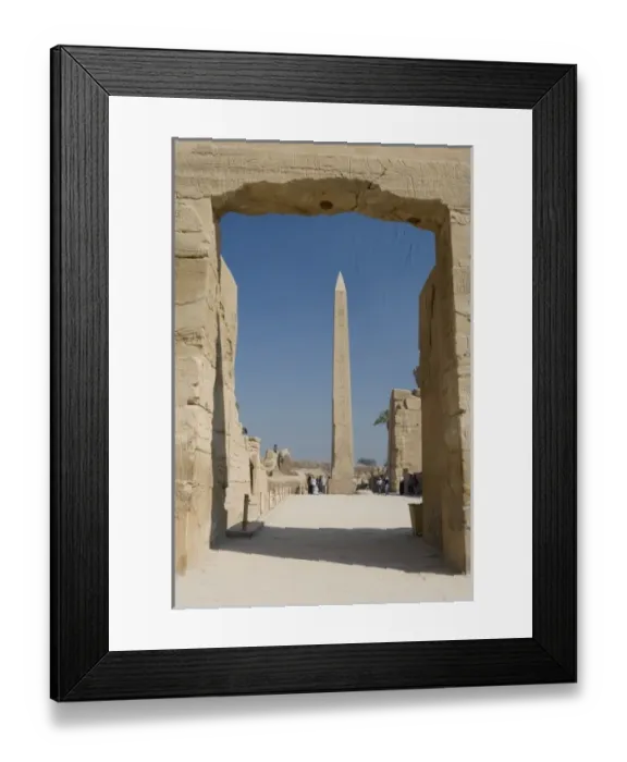 Framed Print : Egypt, Luxor. The obelisk at Karnak Temple rises tall above visitors to the ancient ruins