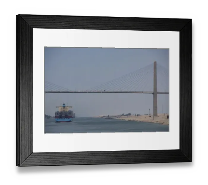 Framed Print : Egypt, Suez Canal. Cargo ship passing under Bridge of Peace (aka Peace Bridge)