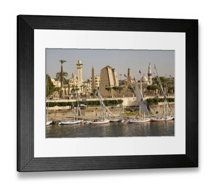 Framed Print : Egypt, Luxor. Tall-masted felucca sailboats moored on the banks for the Nile in front Framed Print : Egypt, Luxor. Tall-masted felucca sailboats moored on the banks for the Nile in front
