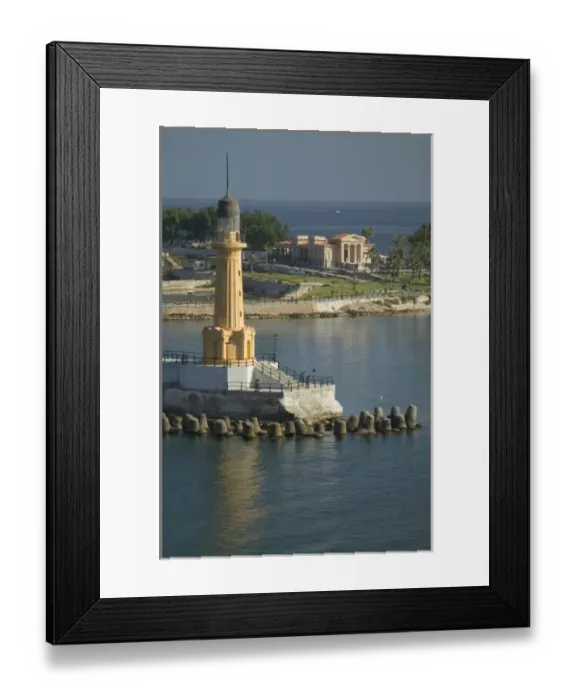 Framed Print : Lighthouse along the Jetty in Alexandria with a small harbor along the Mediterranean Sea, Egypt Framed Print : Lighthouse along the Jetty in Alexandria with a small harbor along the Mediterranean Sea, Egypt