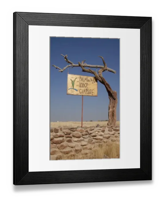 Framed Print : Namibia. Palmwag Lodge sign hung on dead tree