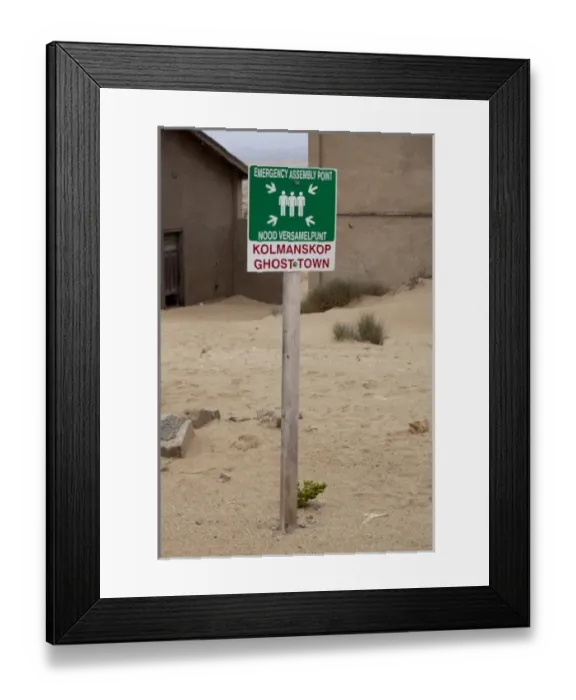 Framed Print : Namibia, Namib Desert, South Coast, Kolmanskop. Emergency assembly point sign in Framed Print : Namibia, Namib Desert, South Coast, Kolmanskop. Emergency assembly point sign in