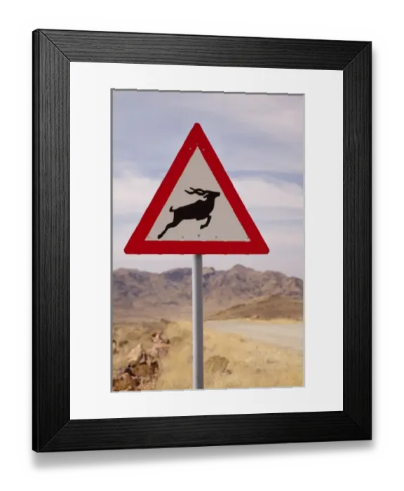 Framed Print : Namibia, Namib Desert, NamibRand Nature Reserve. Kudu crossing caution sign Framed Print : Namibia, Namib Desert, NamibRand Nature Reserve. Kudu crossing caution sign