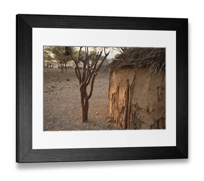Framed Print : Namibia, Opuwo. Partial view of mud hut and Himba village Framed Print : Namibia, Opuwo. Partial view of mud hut and Himba village