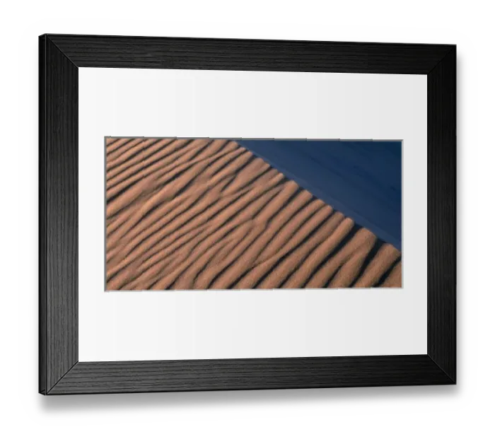 Framed Print : Namibia, Namib Desert, Setting sun lights wind-blown sand along dunes near coastal