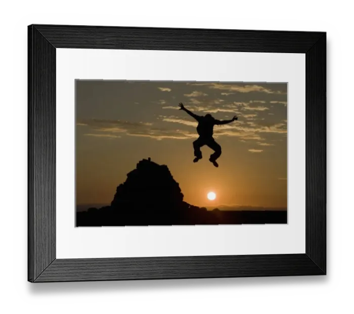 Framed Print : Namibia, Namib Naukluft National Park, Silhouette of man leaping from rock cairn Framed Print : Namibia, Namib Naukluft National Park, Silhouette of man leaping from rock cairn
