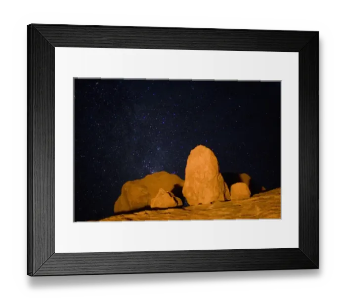Framed Print : Namibia, Usakos, Orange light from campfire illuminates granite boulders near Spitzkoppe