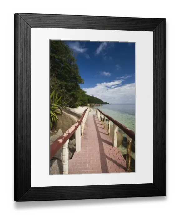 Framed Print : Seychelles, Praslin Island, Anse Bois de Rose, seaside promenade at the Coco de Mer hotel