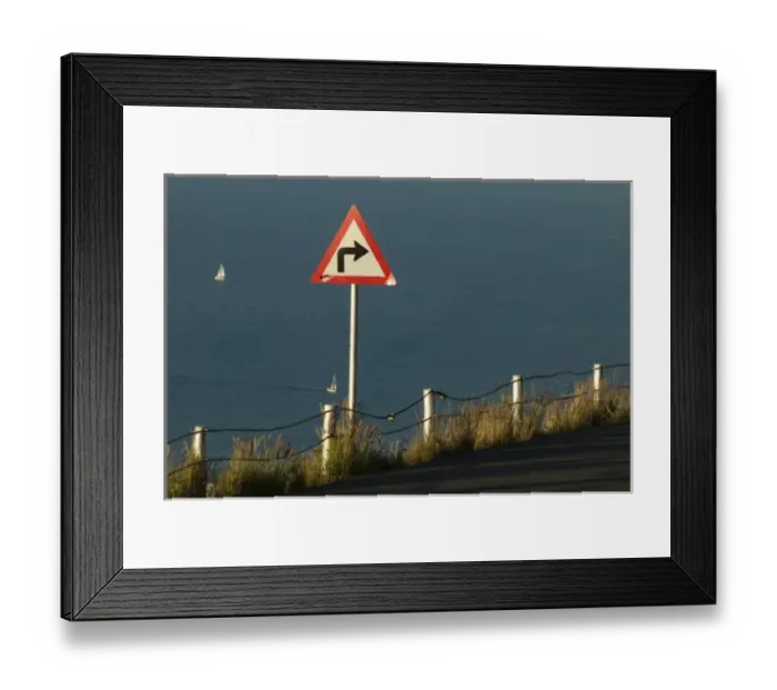 Framed Print : South Africa, Cape Town, Setting sun lights road sign warning of sharp turn along Framed Print : South Africa, Cape Town, Setting sun lights road sign warning of sharp turn along