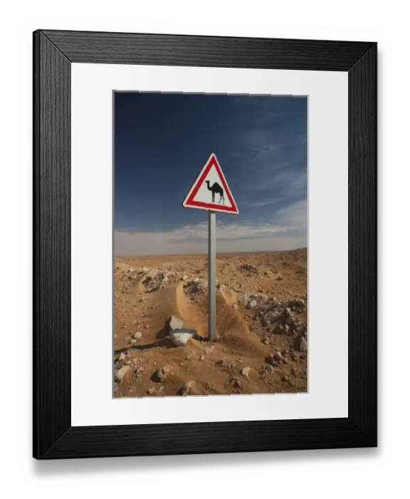 Framed Print : Tunisia, Ksour Area, Ksar Ghilane, Oil Pipeline road with camel crossing sign Framed Print : Tunisia, Ksour Area, Ksar Ghilane, Oil Pipeline road with camel crossing sign