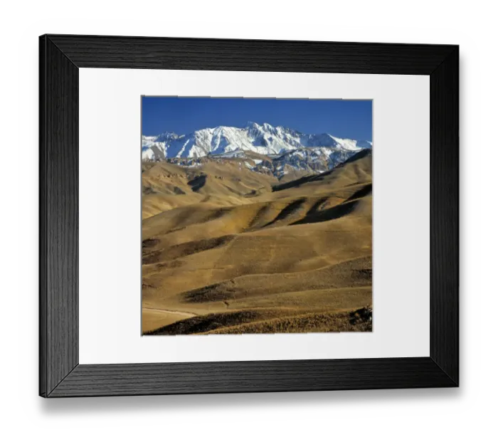 Framed Print : Afghanistan, Bamian Valley. Rolling hills lead to the snow fields of the rugged Hindu