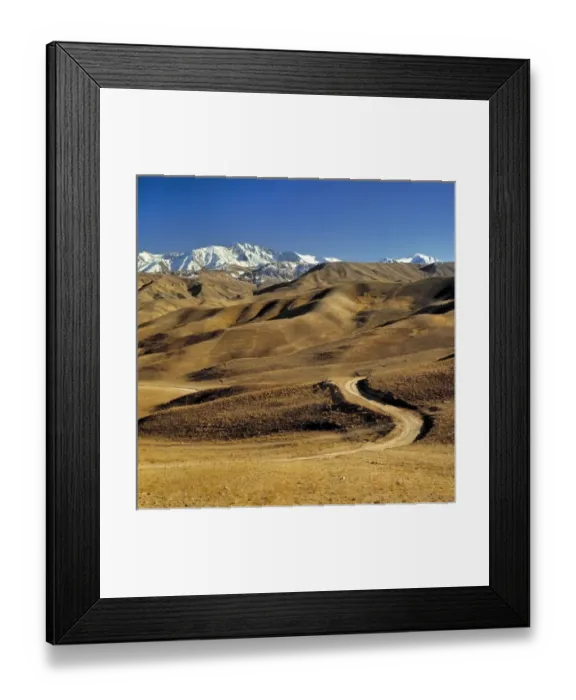 Framed Print : Afghanistan, Hindu Kush Mountains. A lonely dirt road leads into the barren foothills Framed Print : Afghanistan, Hindu Kush Mountains. A lonely dirt road leads into the barren foothills