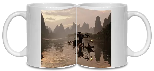Traditional Chinese fisherman with cormorants on Li River at sunrise, near Guilin, China