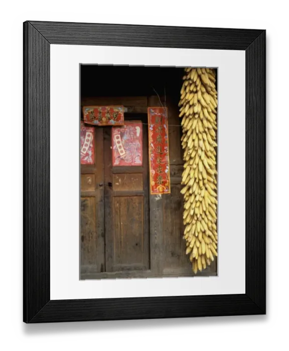 Framed Print : China, Sichuan Province. Dried corn hangs by the doorway of a farm house-Wolong reserve Framed Print : China, Sichuan Province. Dried corn hangs by the doorway of a farm house-Wolong reserve