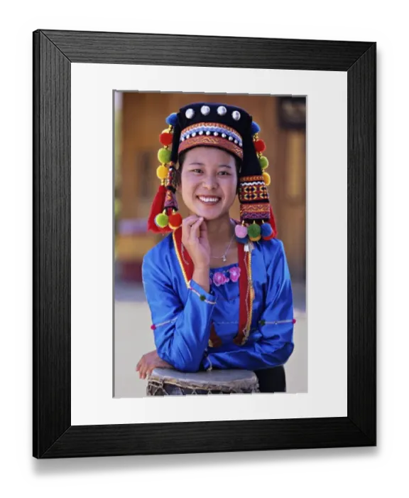 Framed Print : Asia, China, Yunnan Province. Young De ang minority woman in traditional costume with drum