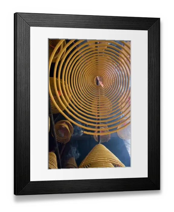 Framed Print : China, Hong Kong, New Territories, Tai Po area. Man Mo Temple. Large coils of burning Framed Print : China, Hong Kong, New Territories, Tai Po area. Man Mo Temple. Large coils of burning