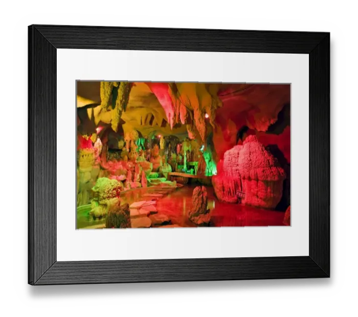 Framed Print : A cave of stalagmites and stalactites lighted with colored lights near the entrance Framed Print : A cave of stalagmites and stalactites lighted with colored lights near the entrance
