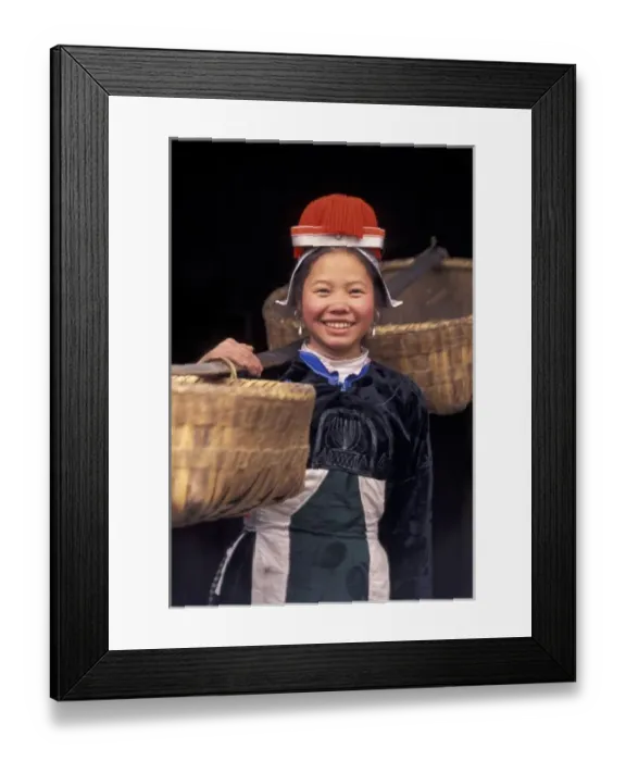 Framed Print : Gejia Miao girl carrying baskets in traditional costume, Matang, Guizhou Province, China Framed Print : Gejia Miao girl carrying baskets in traditional costume, Matang, Guizhou Province, China