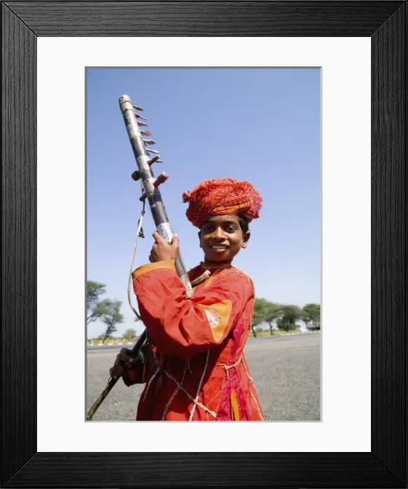 Framed Print : Young boy aged 10 with musical instrument called Sarangi on road to Jodhpur in Rajasthan India