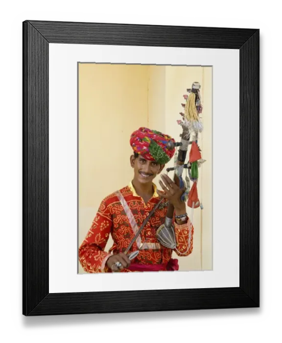 Framed Print : Young man in traditional costume playing old fashioned guitar instrument called a Framed Print : Young man in traditional costume playing old fashioned guitar instrument called a