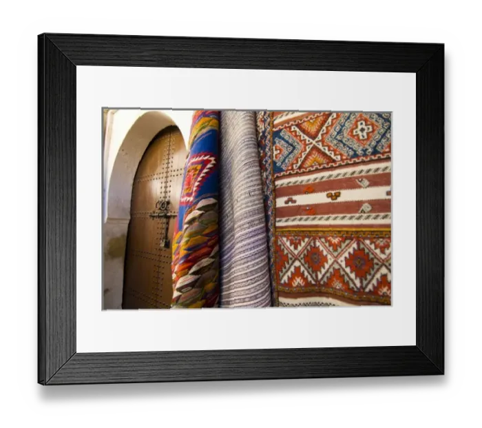 Framed Print : Fez Morocco decorative door and hanging patterned carpets in the old medina Framed Print : Fez Morocco decorative door and hanging patterned carpets in the old medina