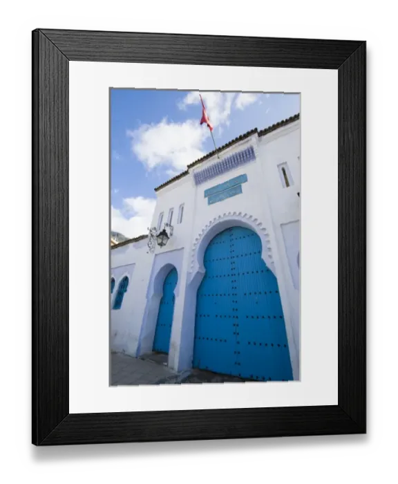 Framed Print : Chefchaouen Morocco blue door and red flag on a building in the medina
