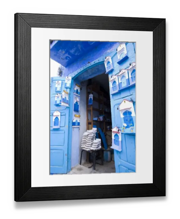Framed Print : Chefchaouen Morocco an artists shop selling painted wooden door plaques in