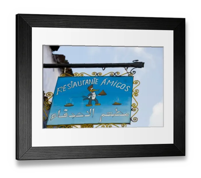 Framed Print : Chefchaouen Morocco restaurant Amigos sign with woodpecker holding a tagine Framed Print : Chefchaouen Morocco restaurant Amigos sign with woodpecker holding a tagine